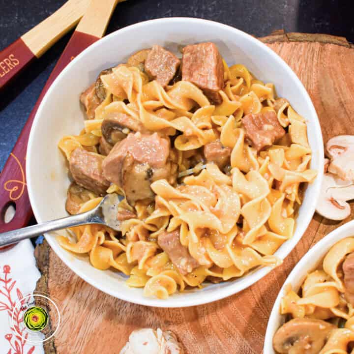 beef stroganoff in white bowl featured image with fork