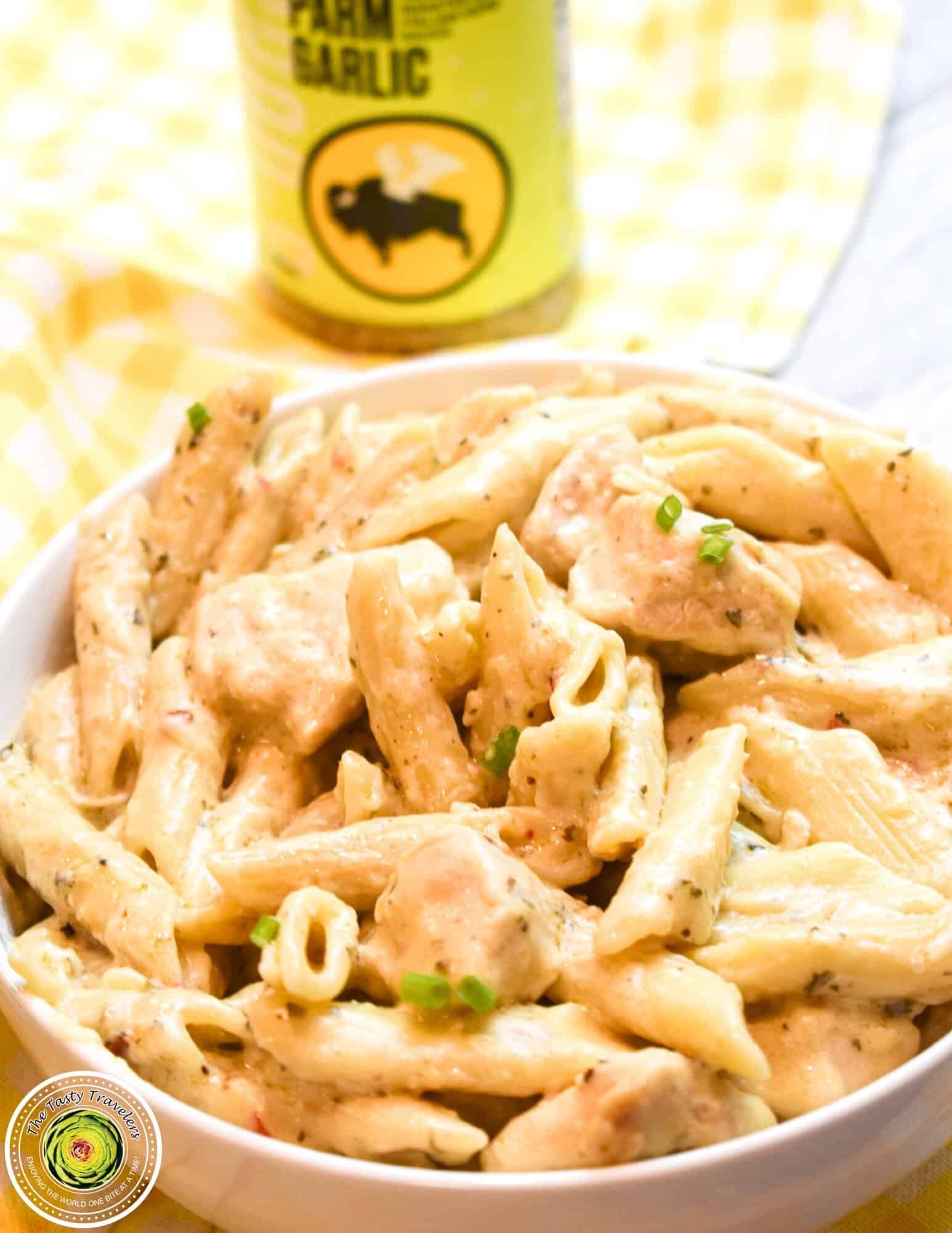 Instant Pot Parmesan Garlic Chicken Pasta in bowl showing creamy sauce and penne pasta
