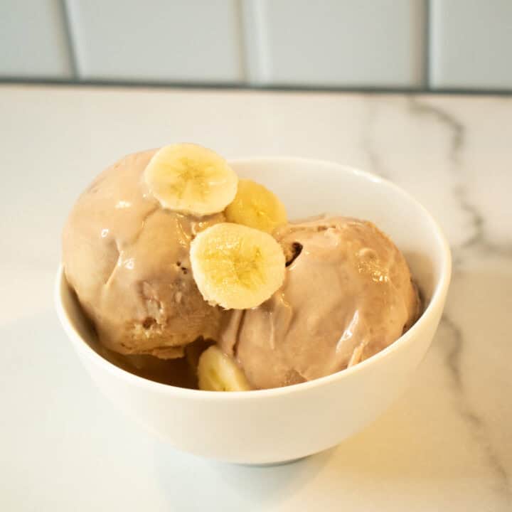 Delicious Ninja Creami peanut butter banana ice cream with fresh banana slices. Perfect for a health.