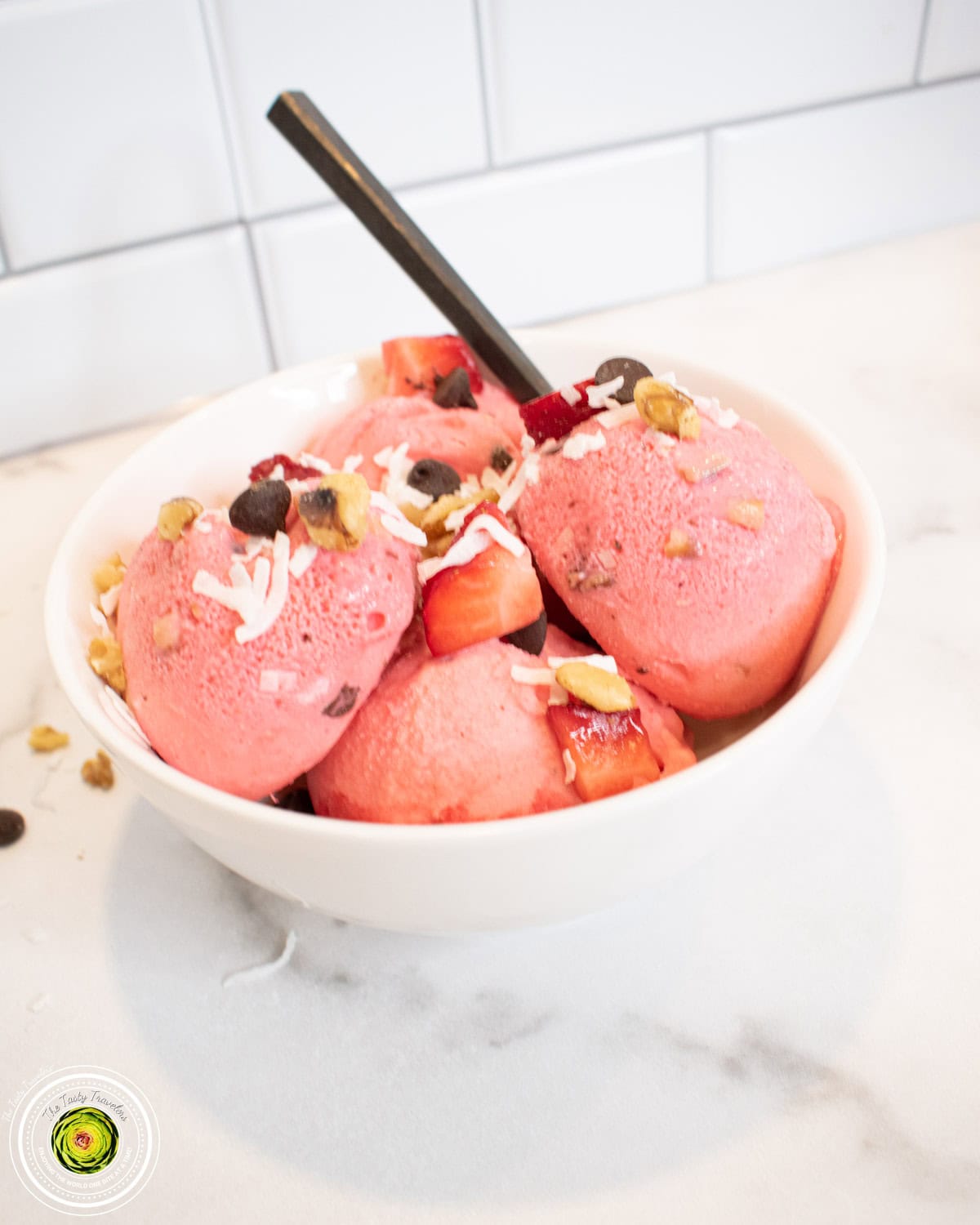 Scooped Ninja Creami strawberry coco-nut protein ice cream with visible coconut and chocolate chips