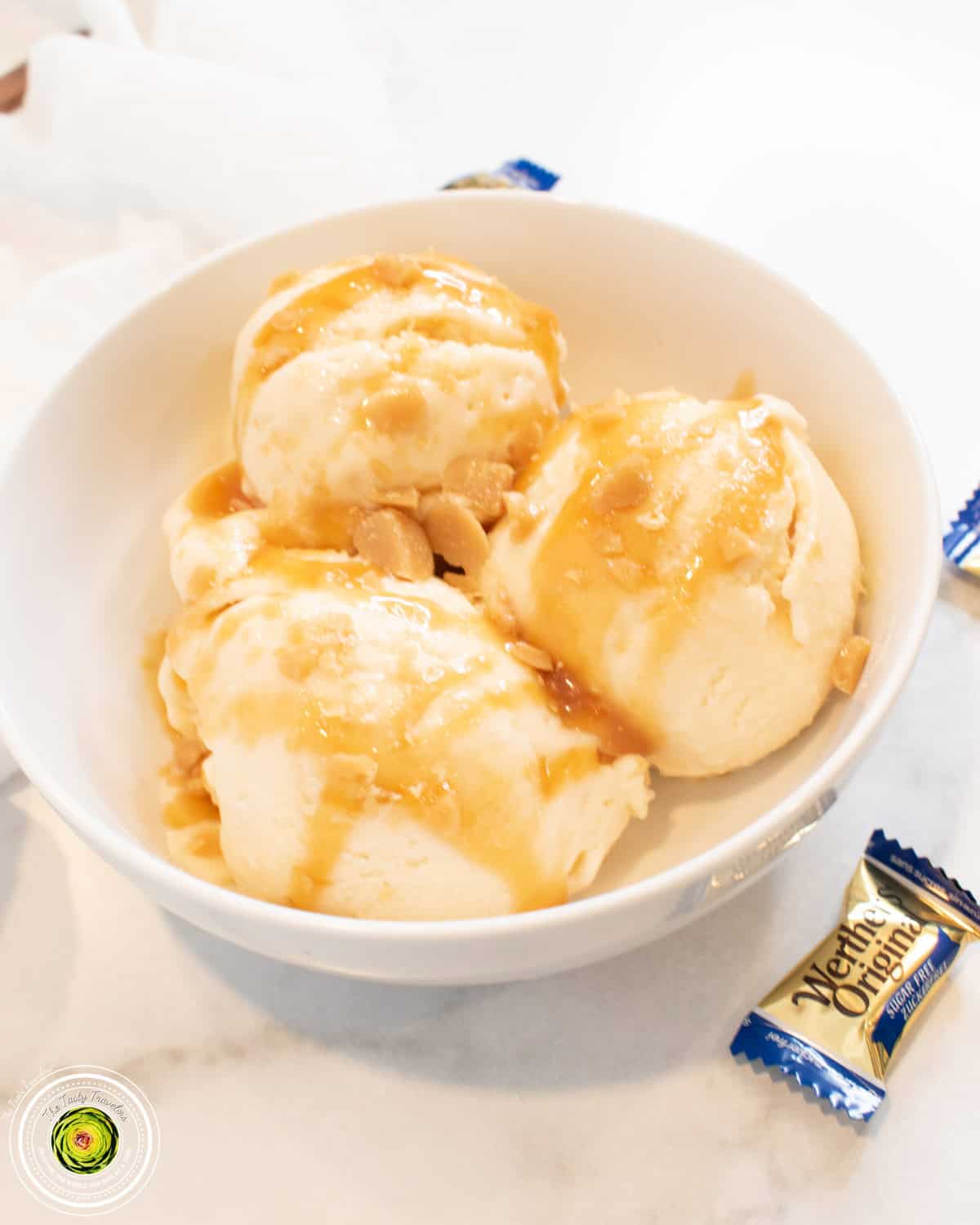 Ninja Creami caramel cookie supreme protein ice cream in a pint container with sugar cookie dough and Werther's pieces on top