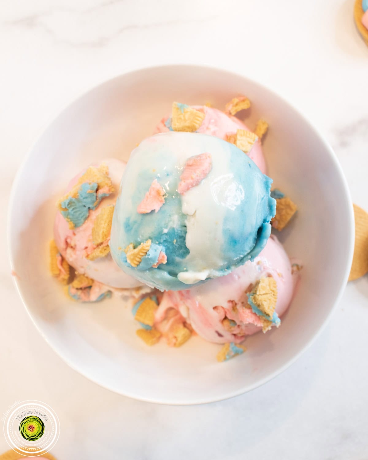 Scooped Ninja Creami cotton candy protein ice cream showing pink, white, and blue colors with Oreo pieces