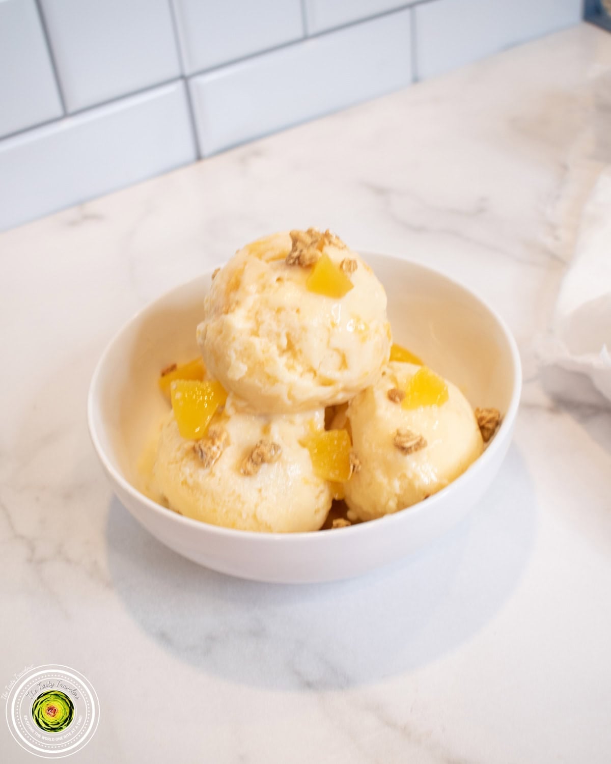 Creamy peach cobbler protein ice cream scooped into a bowl