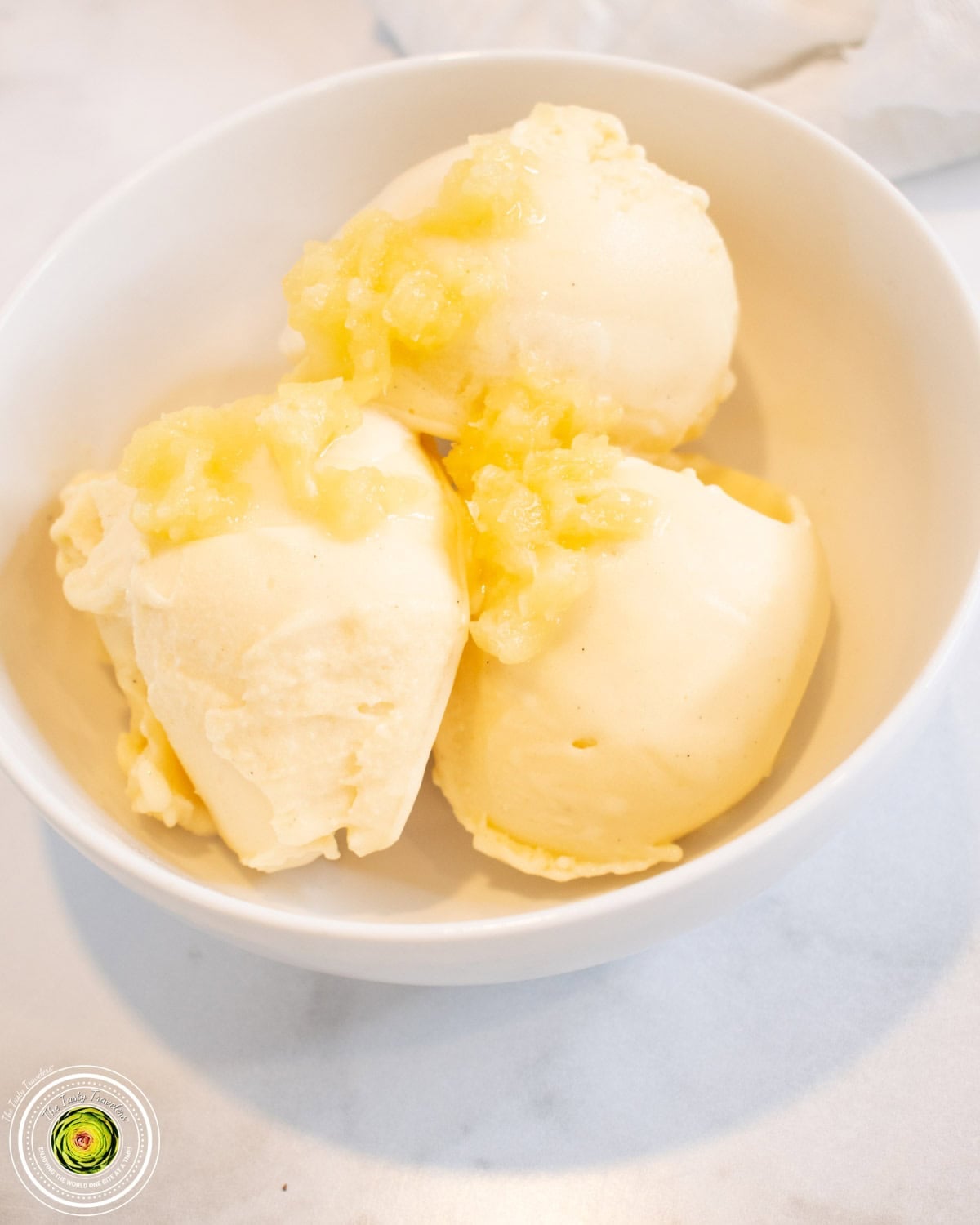 Creamy pineapple Ninja Creami dole whip scooped into a bowl