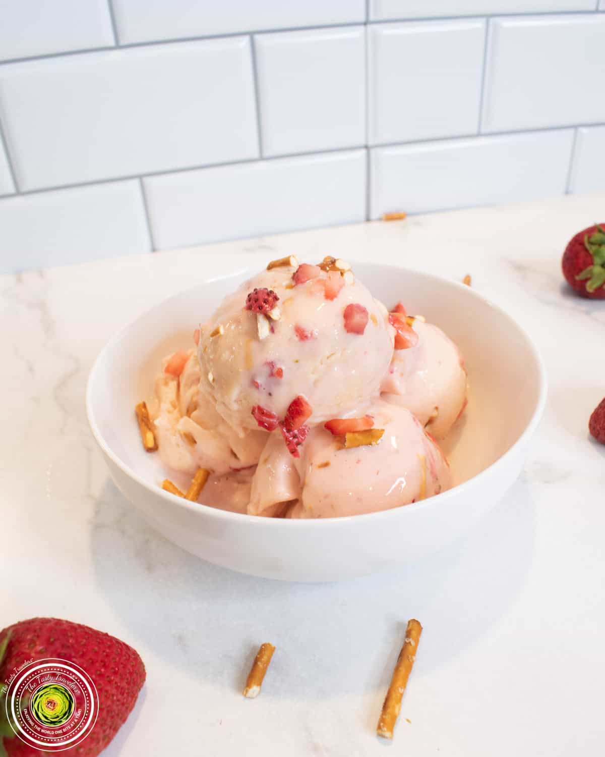 Bowl of Ninja Creami strawberry pretzel pie protein ice cream topped with pretzels and fresh strawberries