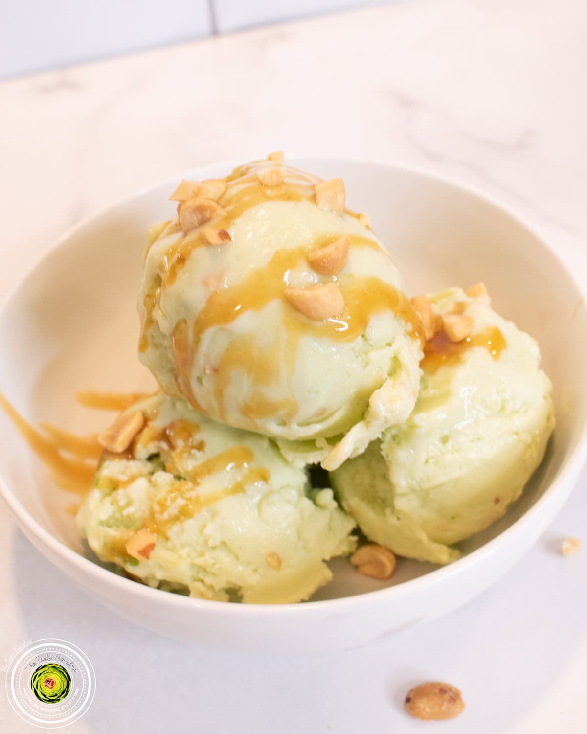 Ninja Creami taffy apple protein ice cream in a pint container with chopped peanuts and green apple on top
