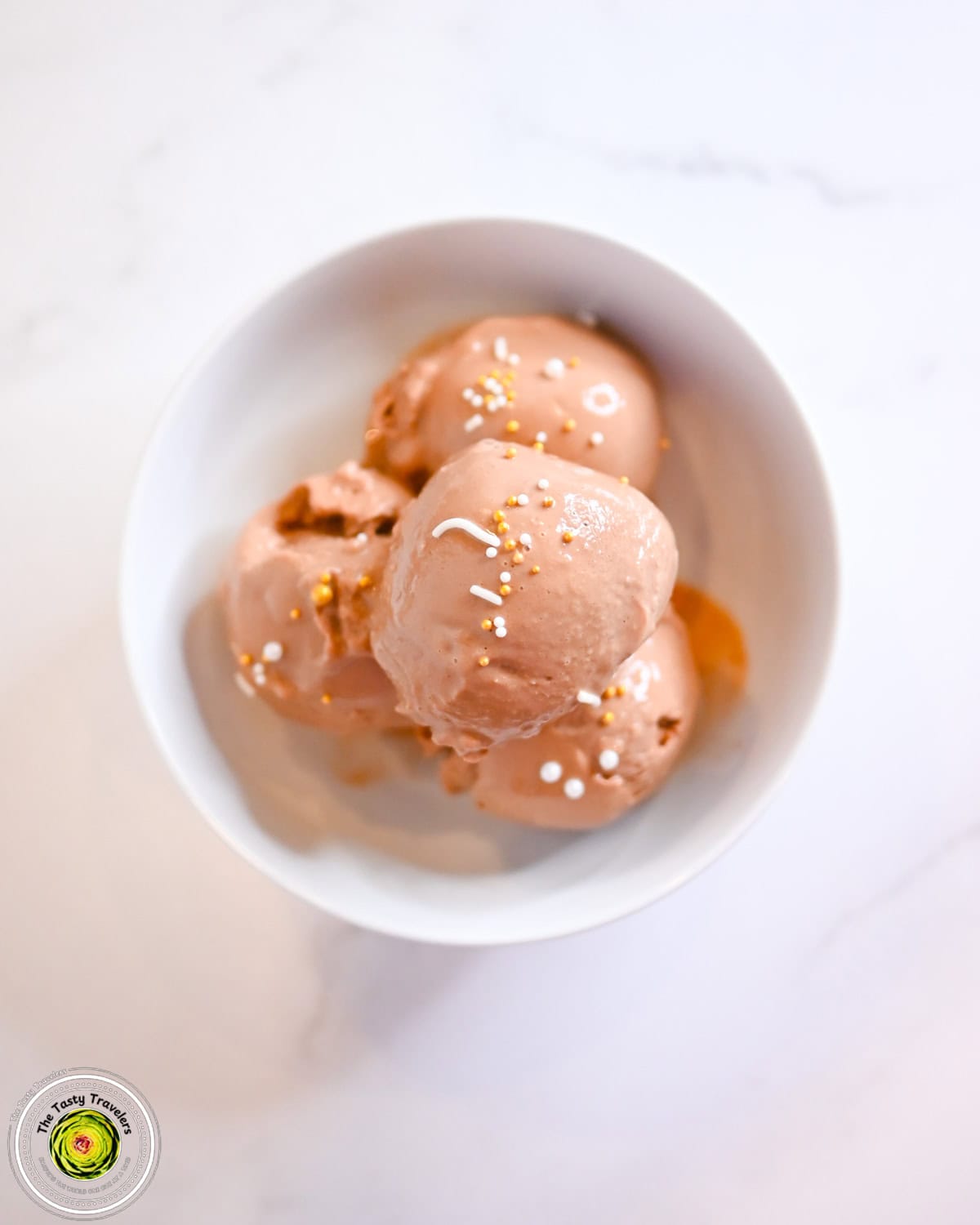 Ninja Creami low calorie chocolate frozen yogurt in a bowl with chocolate sauce drizzle