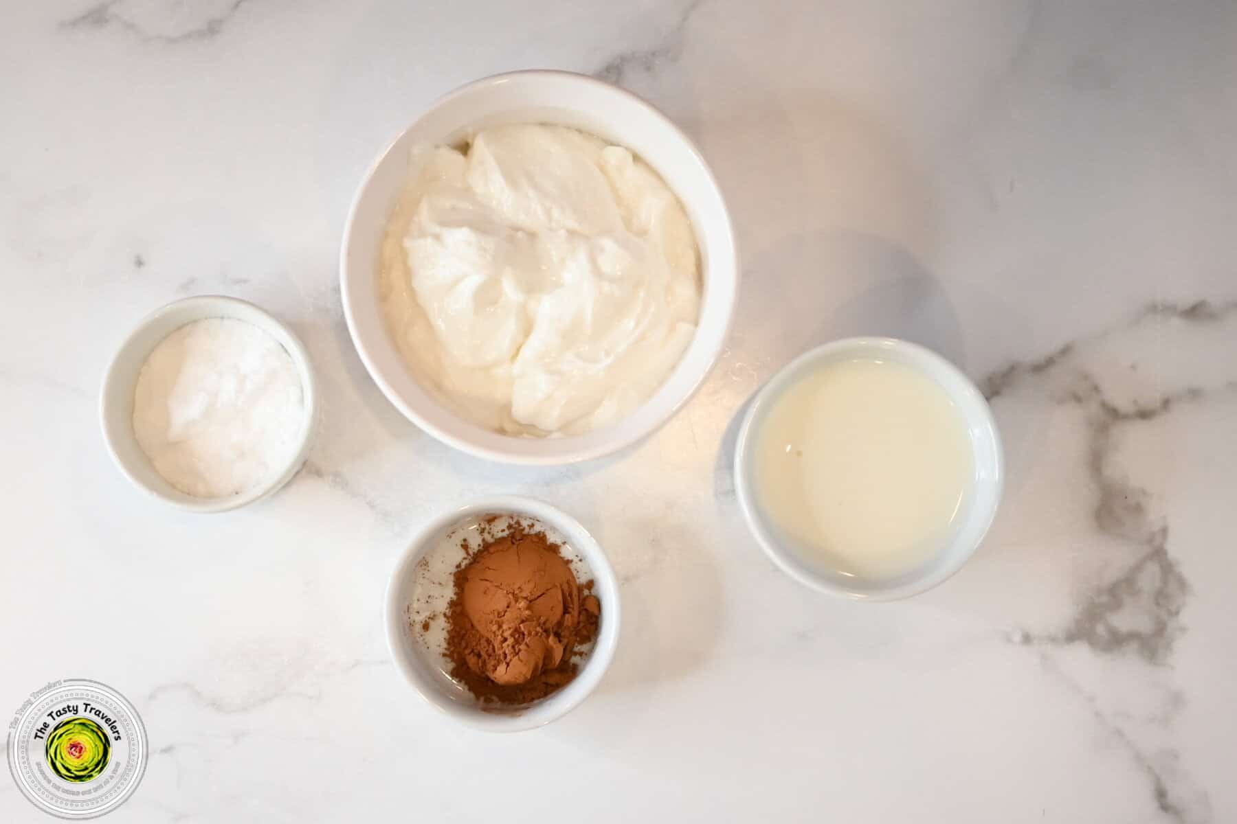Ingredients for Ninja Creami low calorie chocolate frozen yogurt including Chobani zero sugar vanilla Greek yogurt, whole milk, allulose, and cocoa powder
