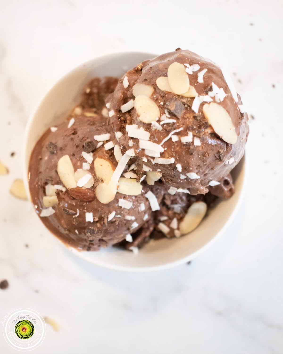 Ninja Creami Almond Joy Protein Ice Cream ingredients showing coconut flakes, sliced almonds, and chopped chocolate chips