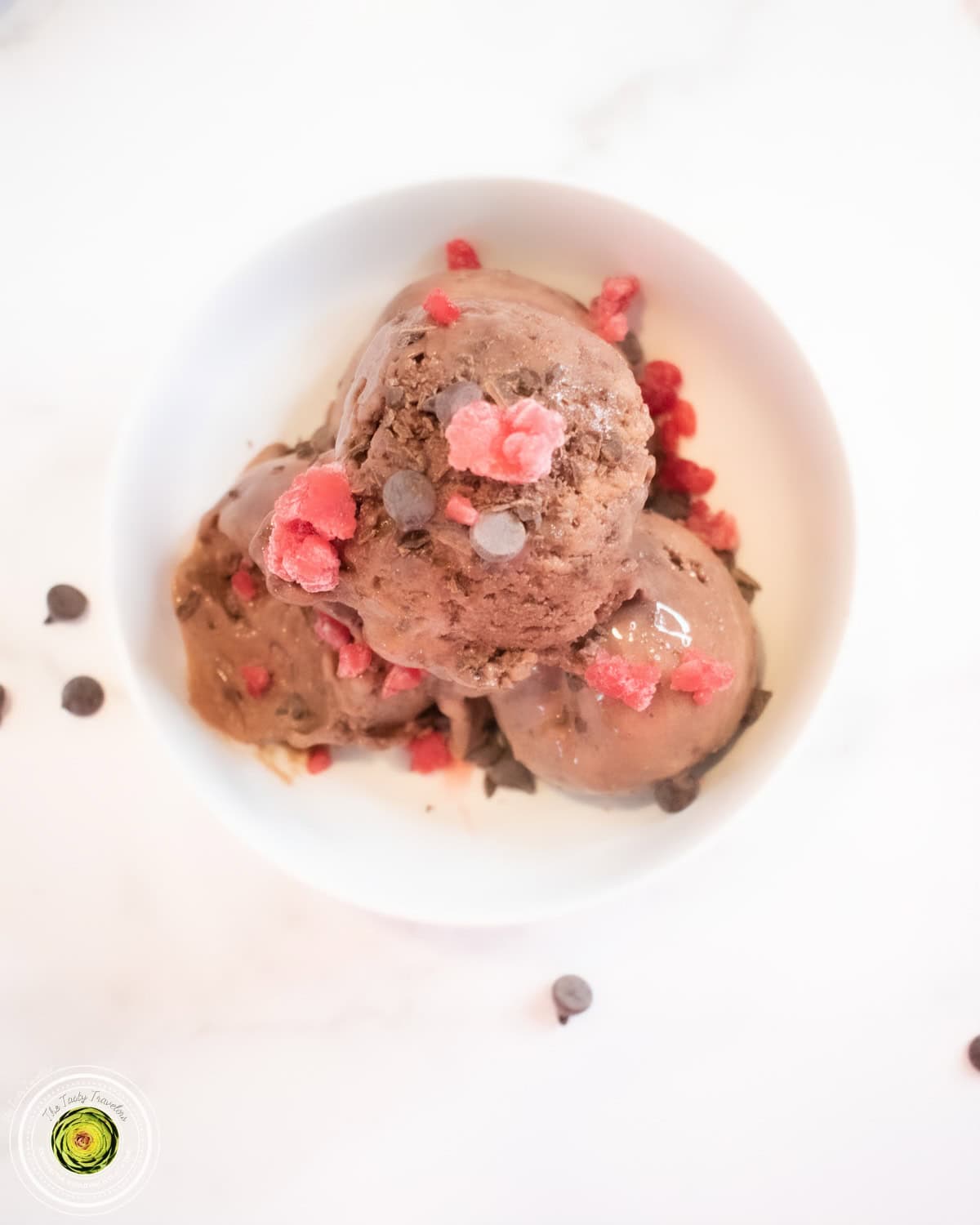 Ninja Creami Raspberry Chocolate Chunk Protein Ice Cream scooped into a bowl showing raspberry and chocolate chunk mix-ins