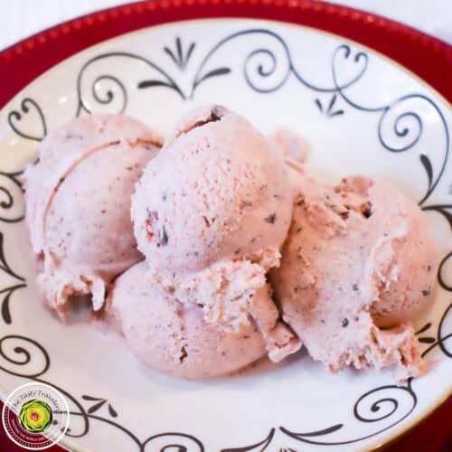 Creamy strawberry ice cream scoops in a decorative bowl, perfect for summer desserts.