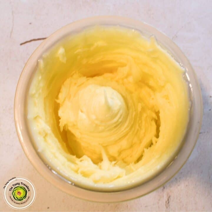 Creamy, smooth butter in a small bowl, ready for cooking or baking. Perfect for enhancing flavors in.