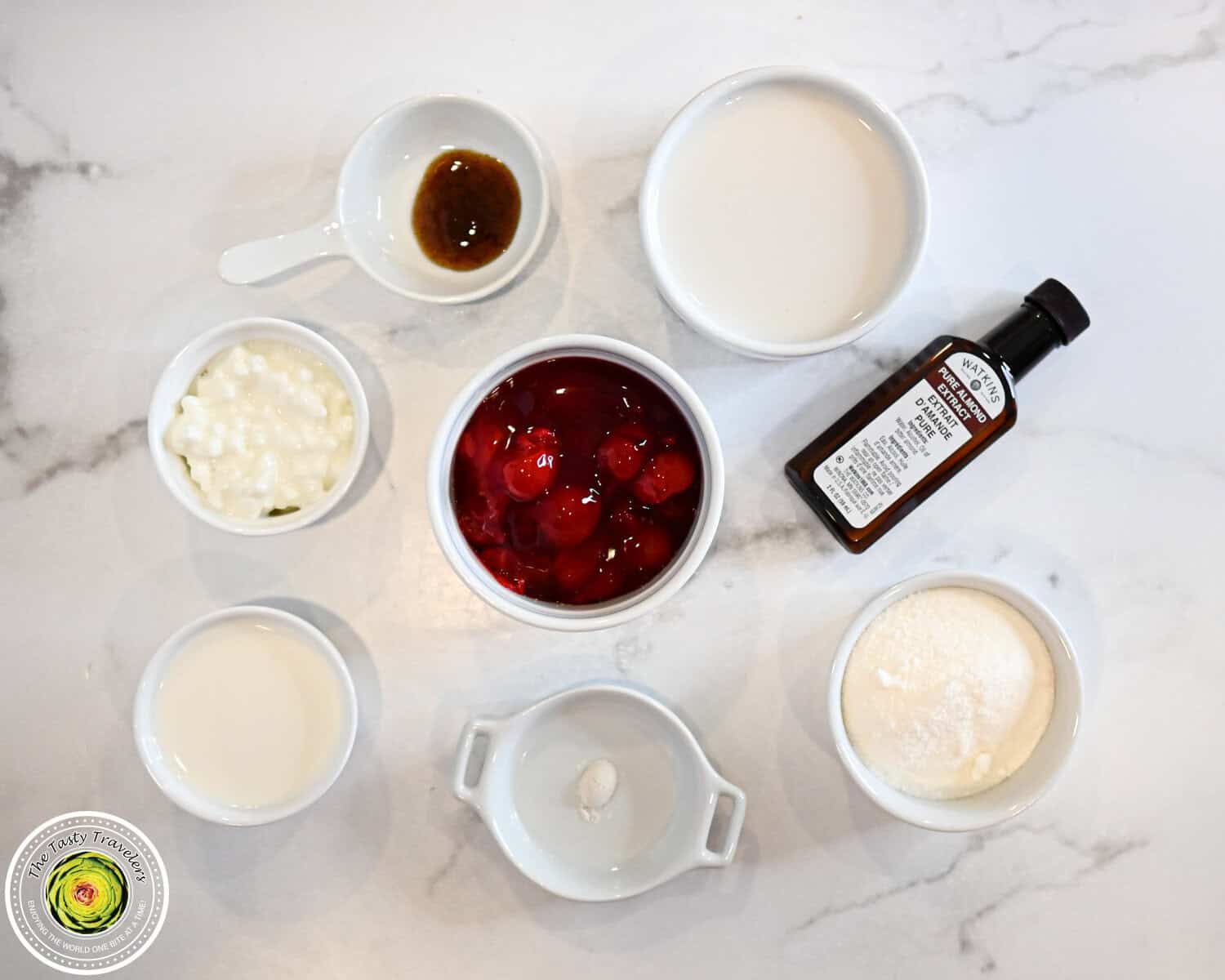 Ingredients for Ninja Creami low calorie cherry almond ice cream including almond milk, half and half, cottage cheese, cherry pie filling, allulose, almond extract, and sliced almonds