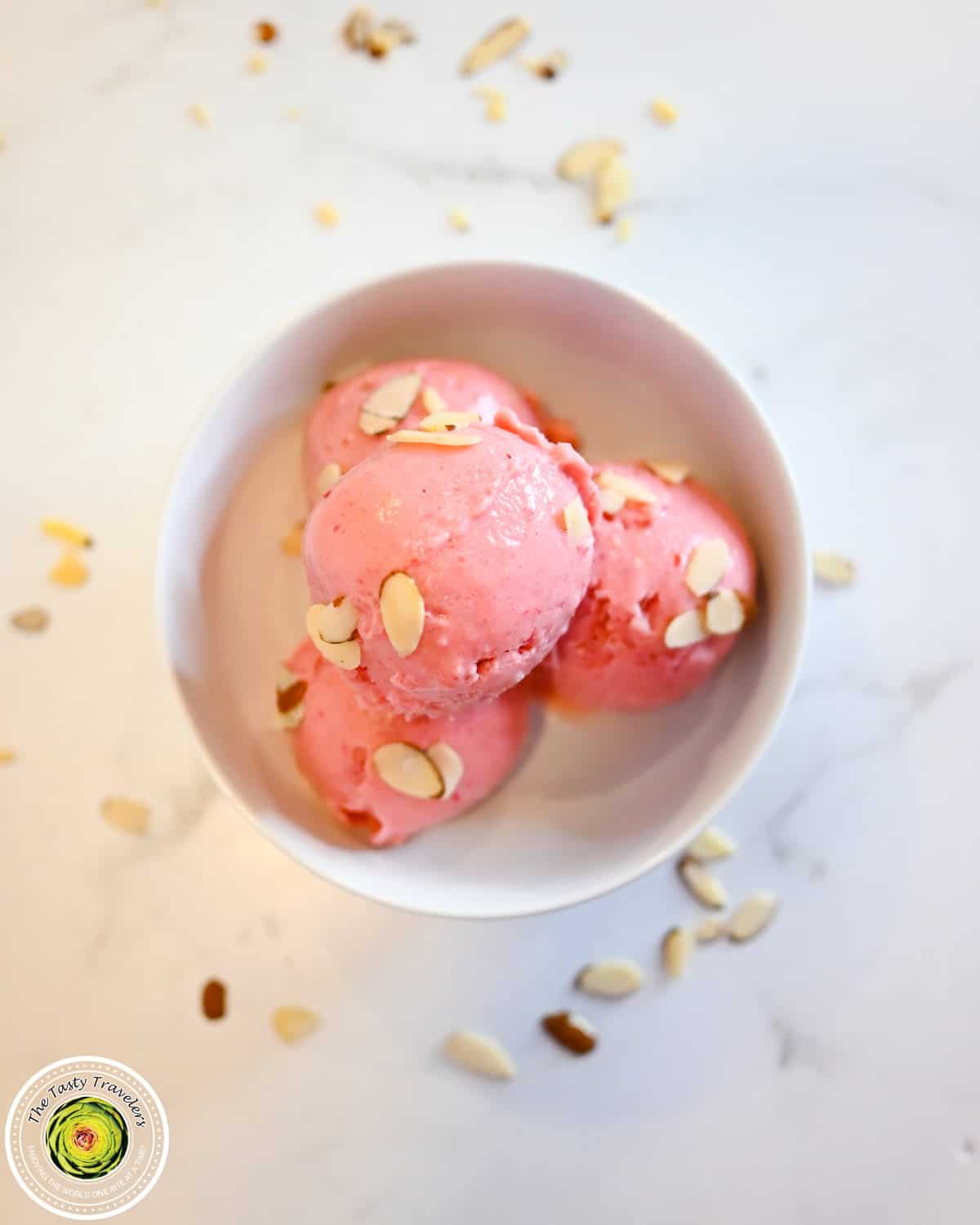 Bowl of Ninja Creami low calorie cherry almond ice cream topped with fresh cherries and sliced almonds