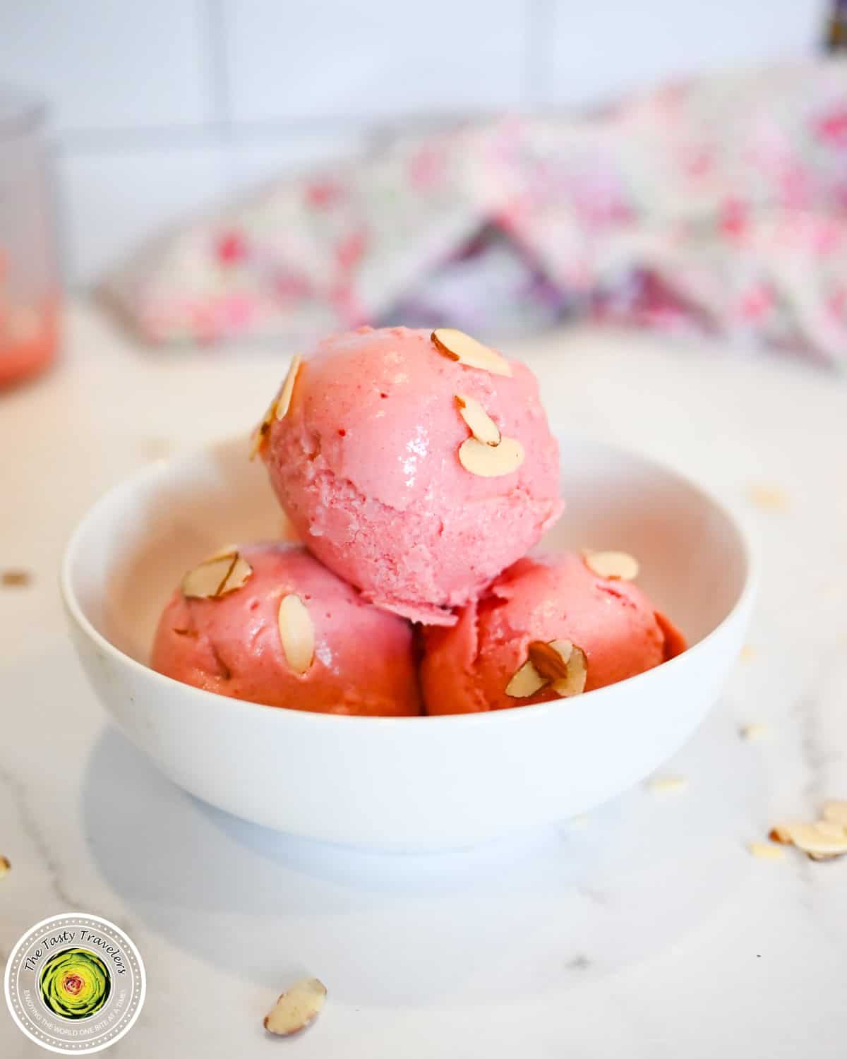 Ninja Creami low calorie cherry almond ice cream in a bowl topped with cherries and sliced almonds