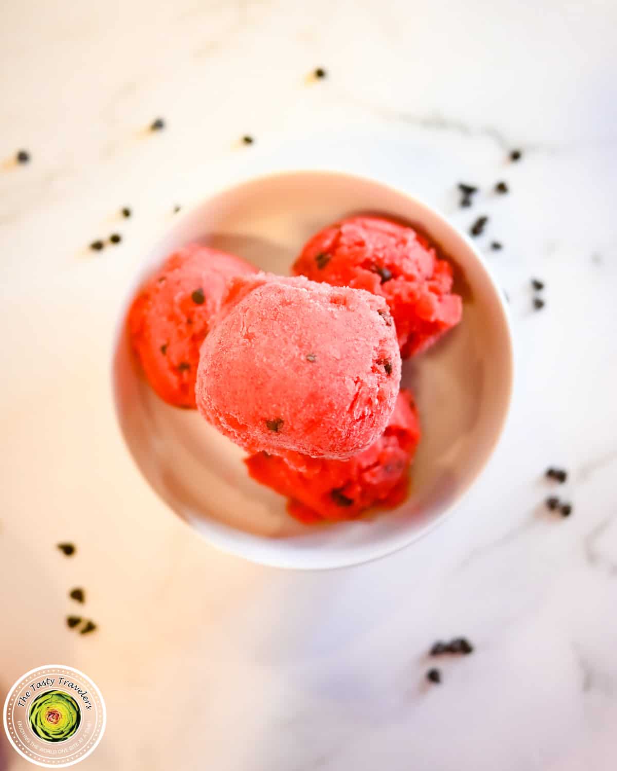 Bowl of Ninja Creami low calorie cherry chocolate chip sorbet topped with fresh cherries