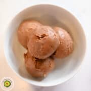 Low calorie chocolate hazelnut ice cream balls in a white bowl.