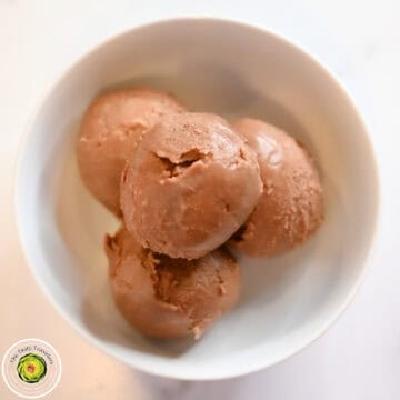 Low calorie chocolate hazelnut ice cream balls in a white bowl.