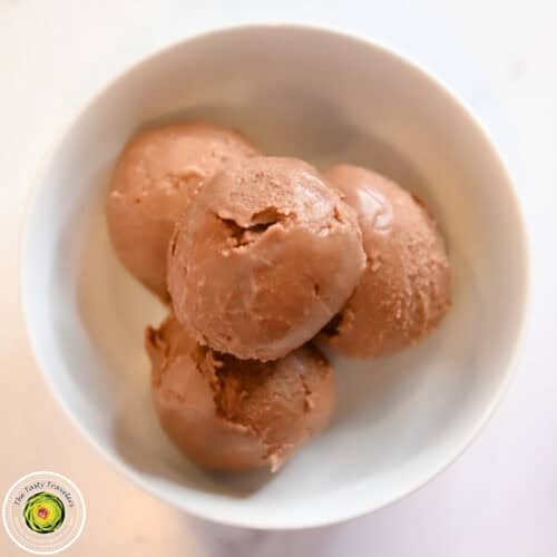 Low calorie chocolate hazelnut ice cream balls in a white bowl.
