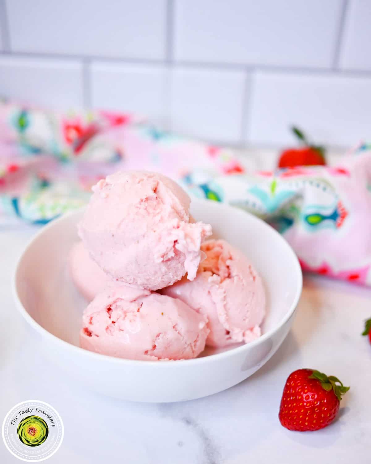 Bowl of Ninja Creami low calorie strawberry ice cream topped with fresh strawberry slices
