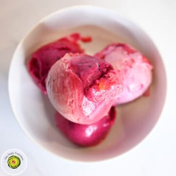 Close-up of colorful ice cream scoops in a white bowl.