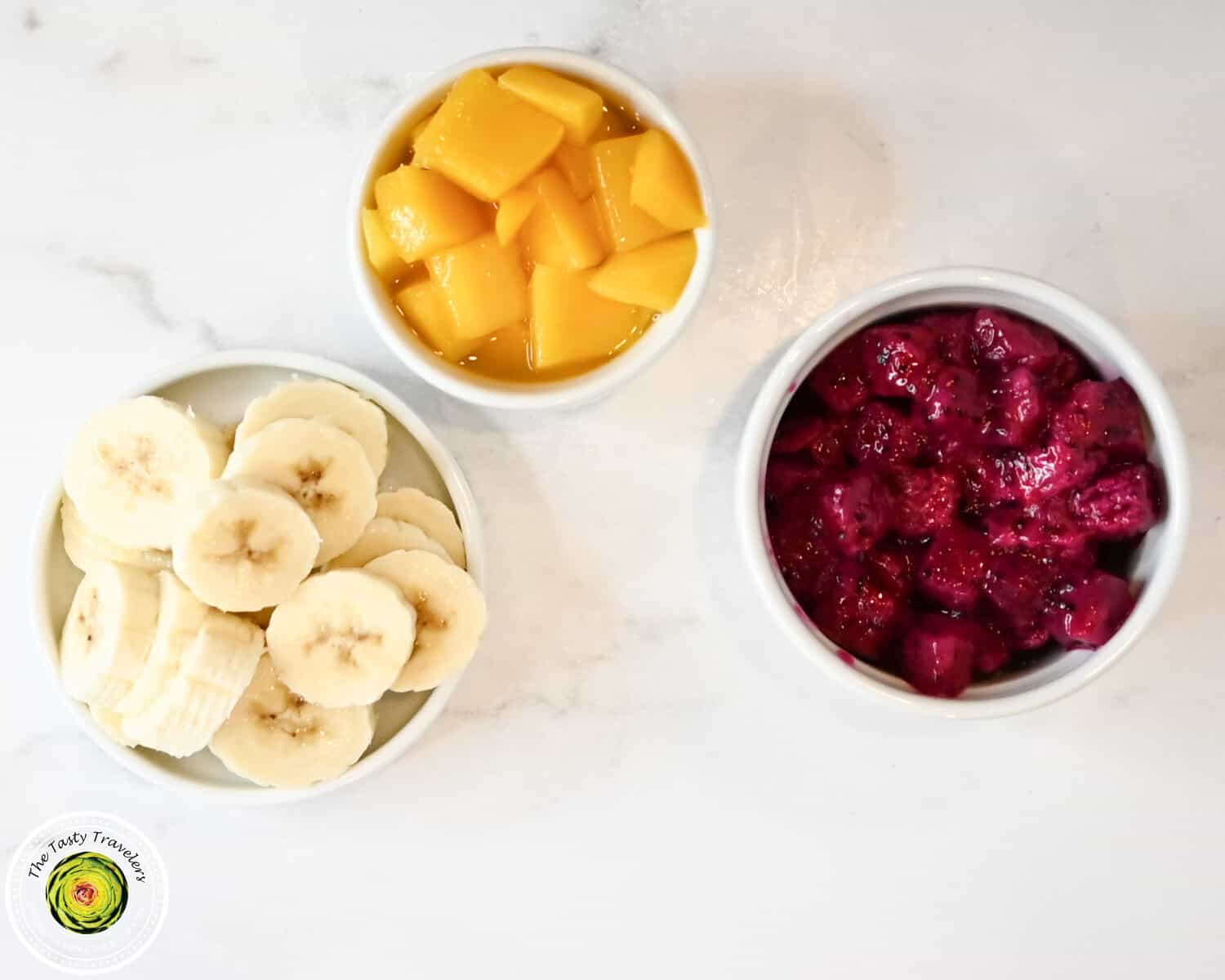 Ingredients for Ninja Creami low calorie tropical triple layered sorbet including fresh banana, canned mango, and dragon fruit