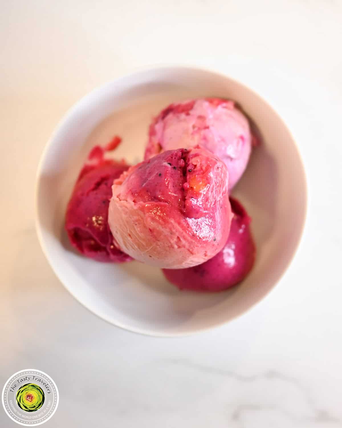 Bowl of Ninja Creami low calorie tropical triple layered sorbet with banana, mango, and dragon fruit