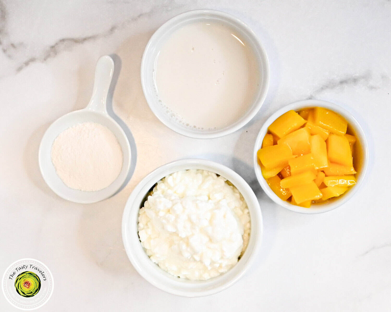 Ingredients for Ninja Creami low calorie mango cheesecake ice cream including diced mango, almond milk, cottage cheese, and cheesecake pudding mix