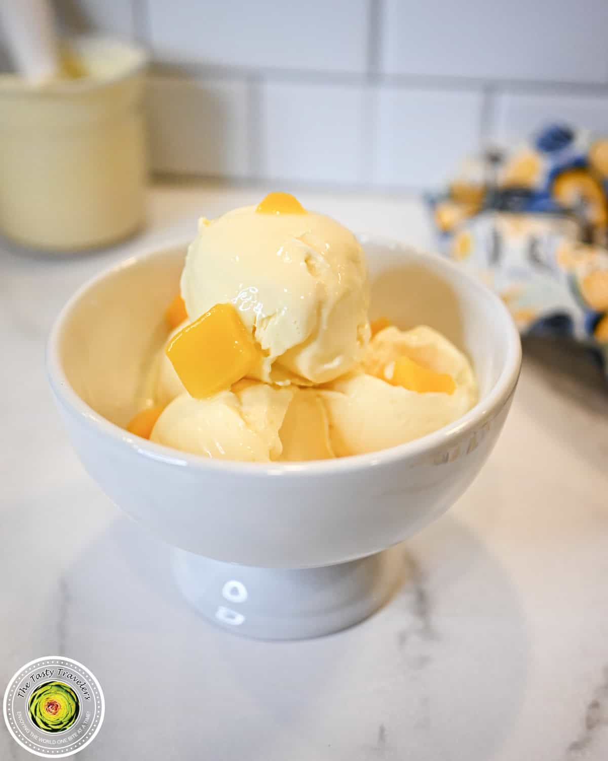 Ninja Creami low calorie mango cheesecake ice cream in a bowl topped with fresh mango