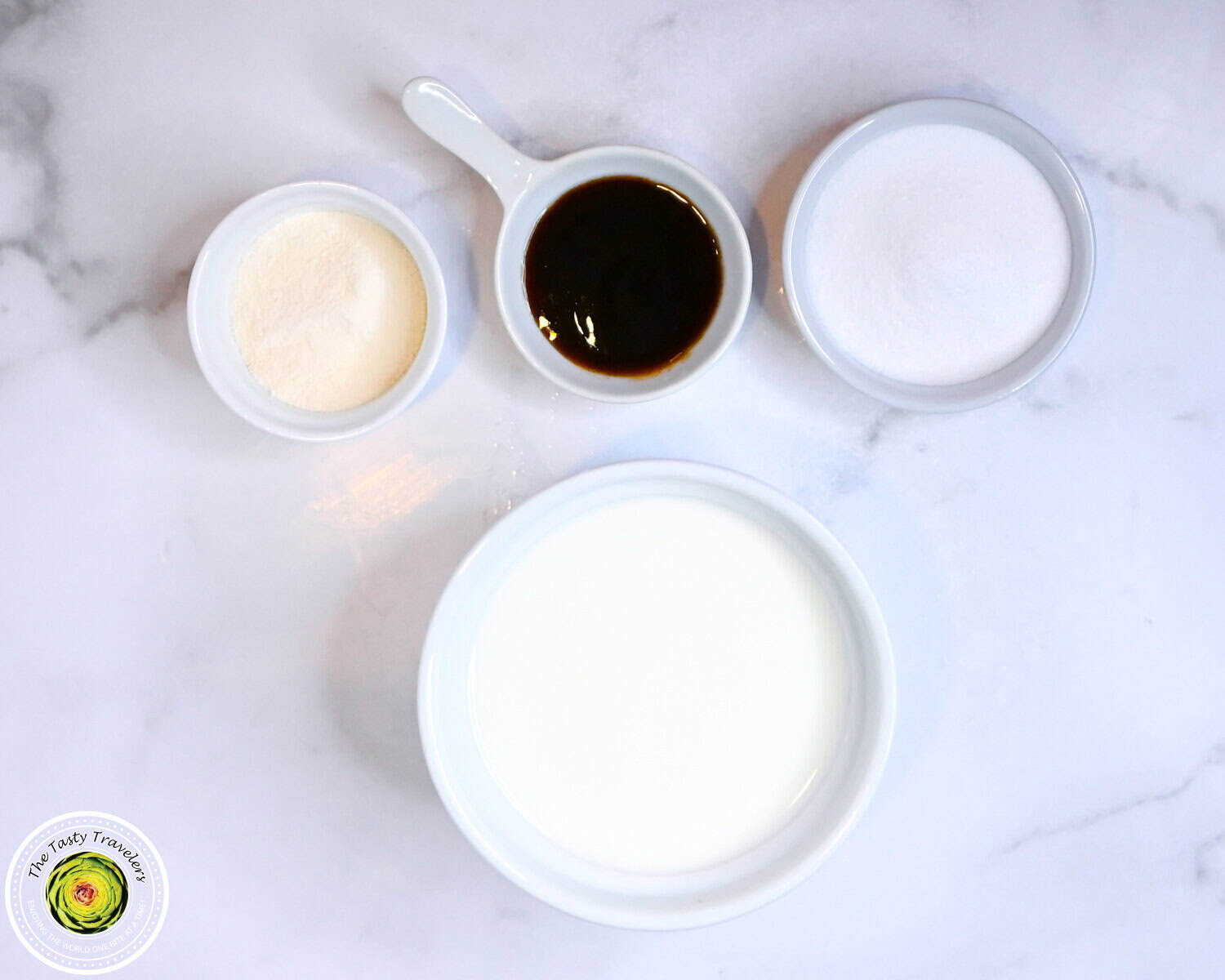 Assorted ingredients for cooking or baking on a marble surface.